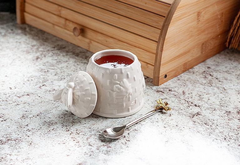 white bee hive honey pot with spoon